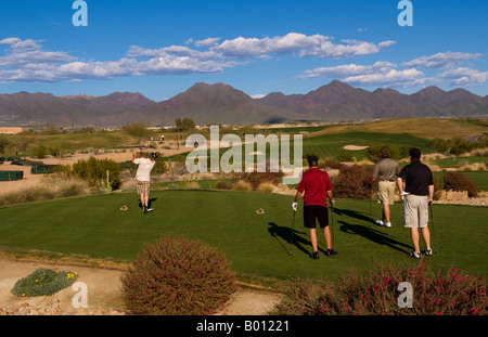 Golfers playing the 16th hole on the Tournament Players Club golf course in tourist area of Scottsdale Phoenix Arizona USA Stock Photo
