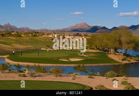 Golfers playing the 12th hole on the Tournament Players Club golf course in tourist area of Scottsdale Phoenix Arizona USA Stock Photo