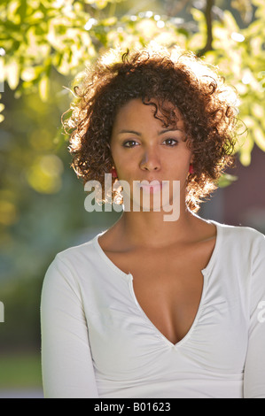 Young African mulata woman - half German half Cuban - in a park Stock Photo