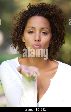 Young African mulata woman - half German half Cuban - blowing a kiss Stock Photo