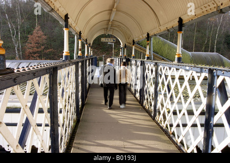 A girl and her grandma cross the bridge at Elmstead Woods railway station to catch a train to London Stock Photo