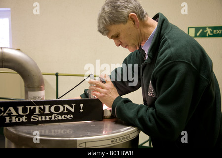 Larghe Scottish Whisky Distillery   Whiskey process, Inspecting Vat or mashing tank at Oban distillery, Scotland uk Stock Photo