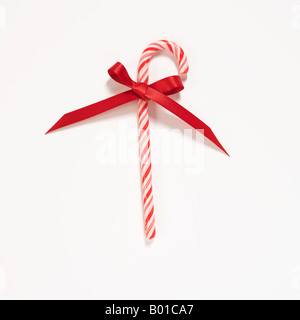 candy cane with red ribbon bow on white background Stock Photo