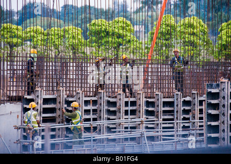 Construction workers building rebar supports for concrete wall Stock Photo
