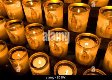 Lit prayer candles inside Notre Dame cathedral in Paris France Stock Photo