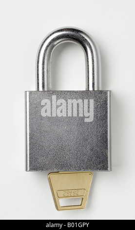 A closed lock with a key isolated on white background Stock Photo - Alamy