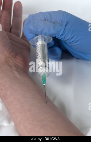 simulating the use of a needle in the arm by the same person with surgical gloves