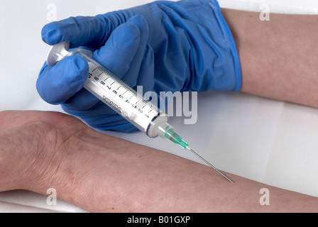 simulating the use of a needle in the arm by the same person with surgical gloves