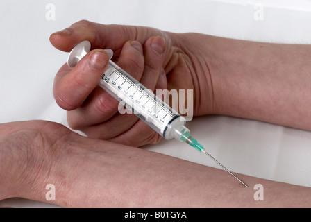 simulating the use of a needle in the arm by the same person no surgical gloves