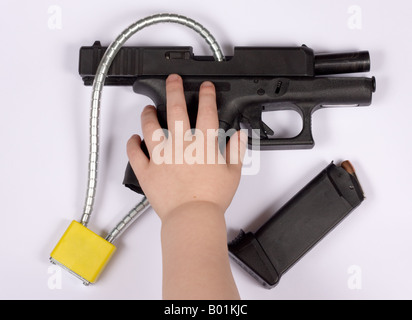 Black handgun with gun lock Stock Photo