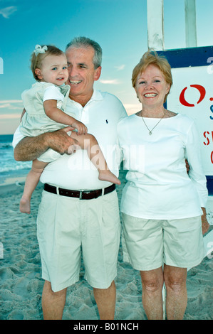Ocean City, New Jersey, USA, Portrait on Beach of Happy Grandparents with Grand Daughter Stock Photo