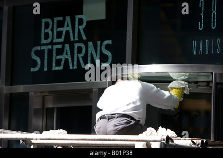 A man polishes a door frame at Bear Stearns world headquarters in New York City one month after merging with JP Morgan Chase. Stock Photo