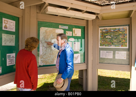 Caucasian Couple (50-55) Reading Trail Map at Davidson River Campground Near Brevard North Carolina USA Stock Photo