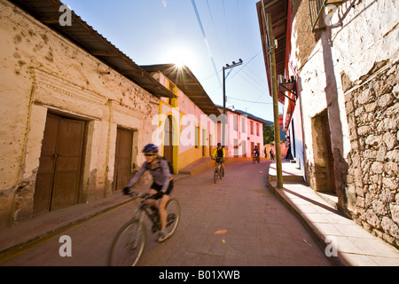 Alida Dierher biking through the town of Batopilas in the Copper Canyon area of Mexico Stock Photo