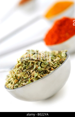 Assorted spices in metal measuring spoons on white background Stock Photo