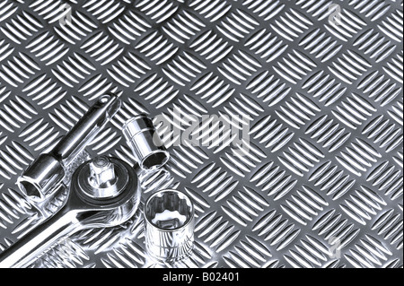 Mechanical background image of socket set on a checkerplate workbench Stock Photo