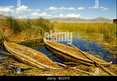 Traditional reed boats crafted from plaited reeds, used by the Uros people to travel between floating islands on Lake Titicaca, Peru. Stock Photo