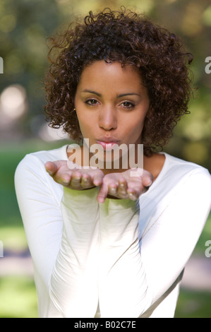 Young African mulata woman - half German half Cuban - blowing a kiss Stock Photo