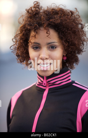Girl smiling, in sports jacket, ethnic background of model half German half Cuban Stock Photo