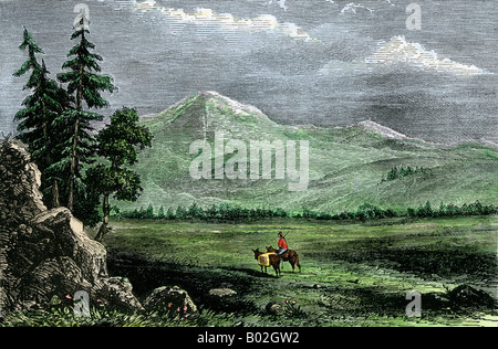 Traveler with a pack horse in the Rocky Mountains. Hand-colored woodcut Stock Photo