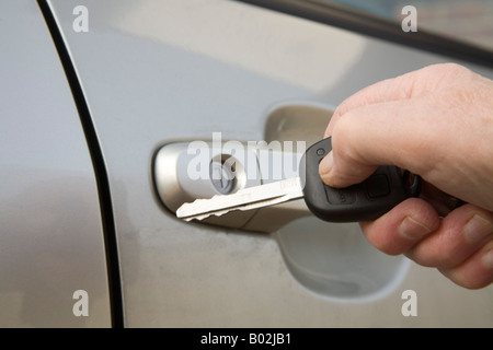 Still Life Studio Close up A woman's hand locking a car door with the remote control part of the key Stock Photo