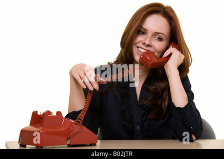 Talking on old style telephone Stock Photo