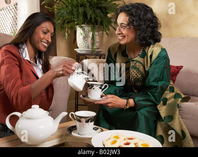 Indian mother and adult daughter having tea Stock Photo