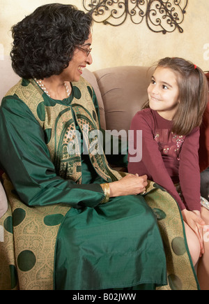 Indian grandmother and granddaughter smiling at each other Stock Photo