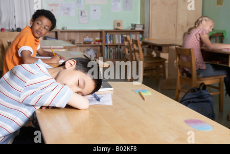 Asian boy sleeping in classroom Stock Photo