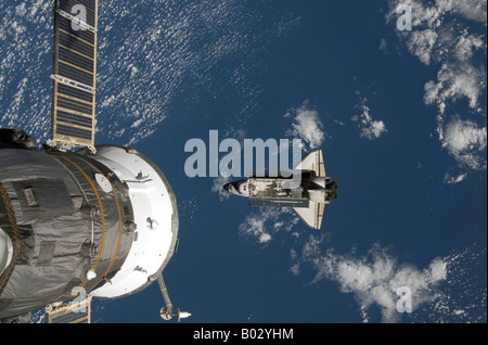 Space Shuttle Endeavour backdropped by a blue and white Earth. Stock Photo