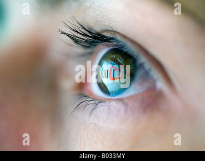 Logo from Video file sharing website YouTube is reflected from computer screen onto womans eye 2008 Stock Photo