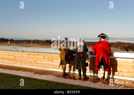 men dressed as traditional soldiers take in the view from the roof of the visitors centre at Culloden Stock Photo