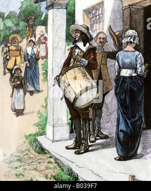 Drummer calling early New England colonists to church service 1600s. Hand-colored woodcut Stock Photo