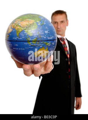 Businessman holding a globe Stock Photo