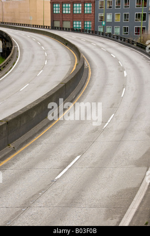 empty roadway, curing left, buildings behind Stock Photo