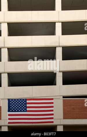 A US flag hang on the side of a multi level parking lot in Little Rock, Arkansas Stock Photo