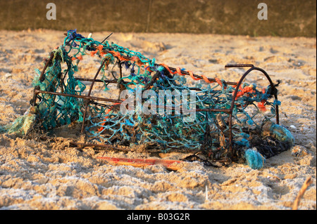 Washed up damaged crab net on Cromer Beach on the Norfolk Coast Stock Photo