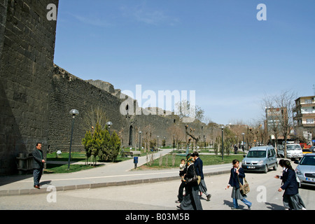 Pedestrians walk towards the Urfa gate in the Diyarbakir city walls Turkey Stock Photo