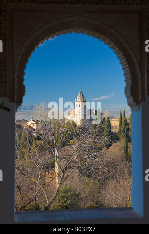 View of Alhambra through an arched window of portico beside the Court of Long Pond at Generalife - designated a UNESCO Stock Photo