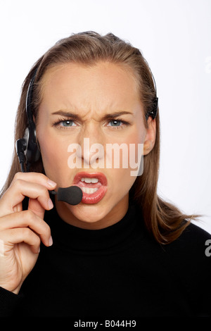 Angry Businesswoman Talking on Headset Stock Photo