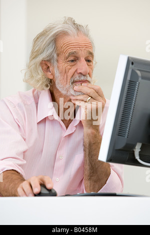 Senior man using computer Stock Photo