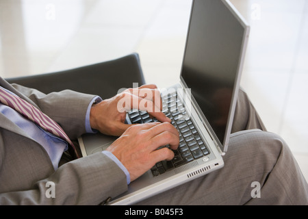 Businessman typing on laptop Stock Photo
