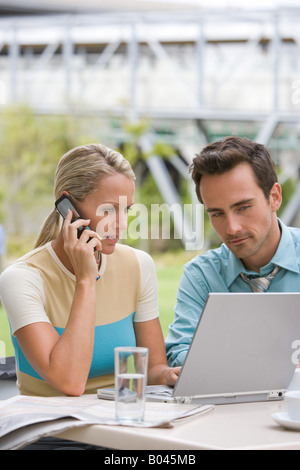 Colleagues using a laptop computer Stock Photo