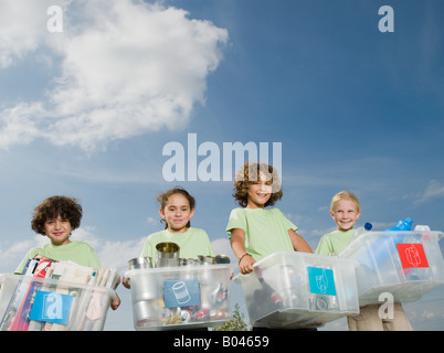 Children carrying boxes of recycling Stock Photo