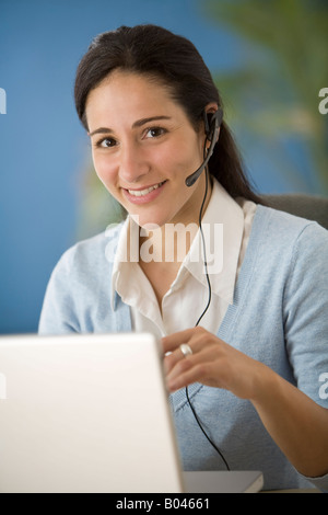 Woman with Headset and Laptop Computer Stock Photo