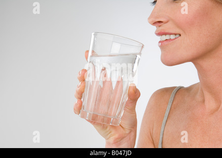 A woman holding a glass of water Stock Photo