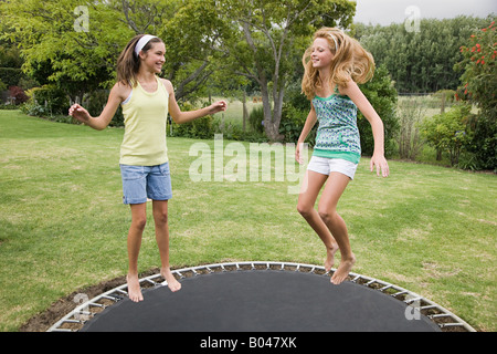 Teenage girls jumping on a trampoline