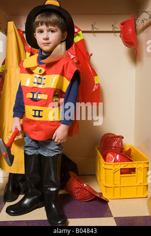 A boy pretending to be a firefighter Stock Photo