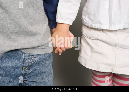 A boy and girl holding hands