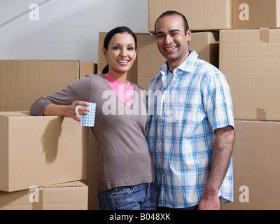Portrait of a couple taking a break from moving house Stock Photo